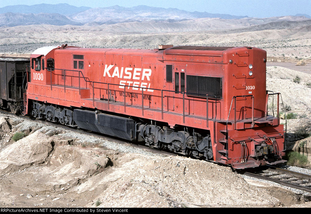 Kaiser Steel U30C KSCX #1030 is rear helper on an iron pellet train.